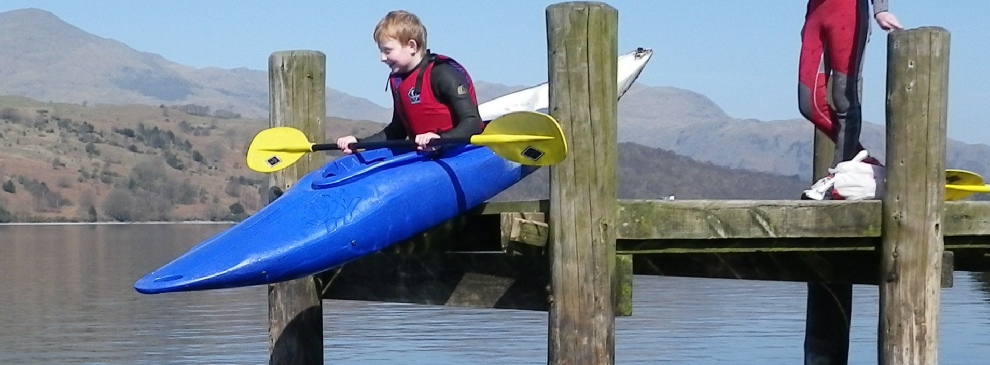 Kayaking taking the plunge.  Our kayaks are stable, easy to paddle and it's great fun to kayak on the Lake District lakes.  For kayaking we give you wetsuits, waterproofs and a bouncey aid to keep you safe and warm.